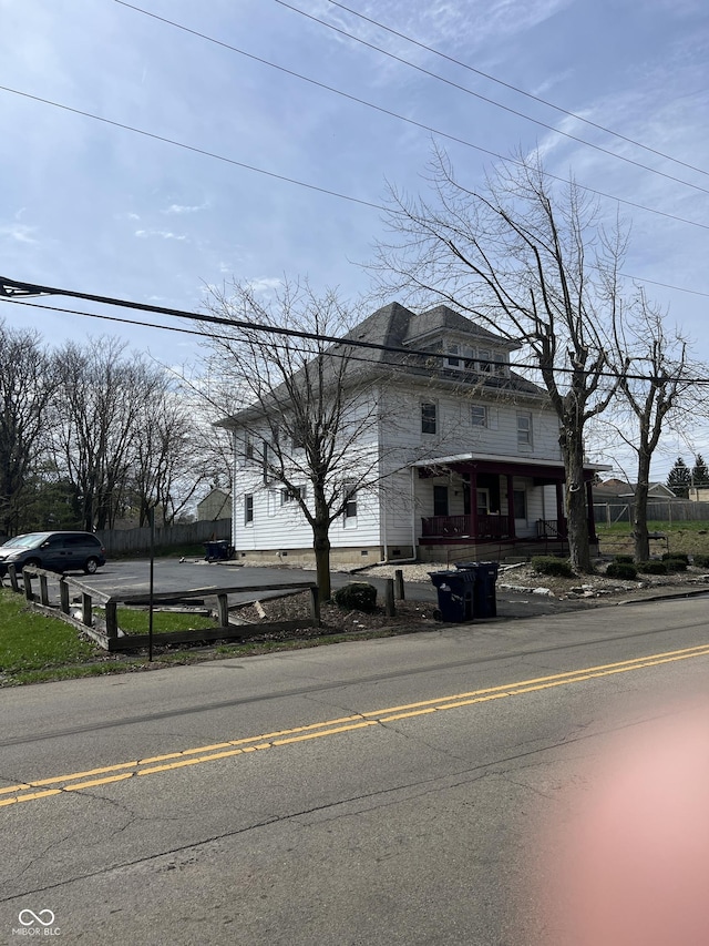 traditional style home featuring fence