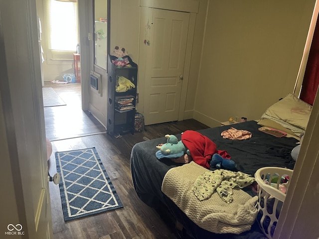 bedroom with wood finished floors and baseboards