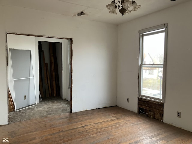 unfurnished room with hardwood / wood-style flooring
