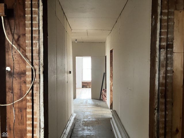 hall with hardwood / wood-style floors