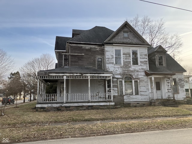 view of front of property with covered porch, crawl space, and a shingled roof