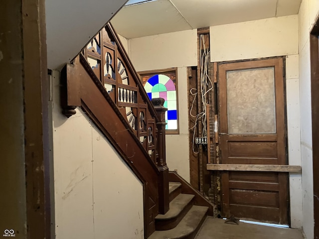 stairs with concrete flooring