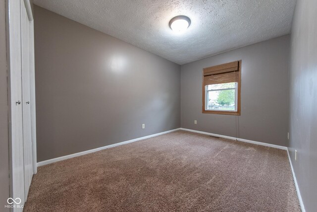 980 Red Maple Ct, Greenwood, IN 46143 - unfurnished room featuring a textured ceiling, carpet flooring, and baseboards