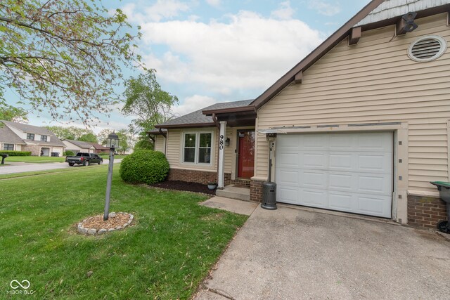 980 Red Maple Ct, Greenwood, IN 46143 - view of front of home with a front yard, brick siding, a garage, and driveway