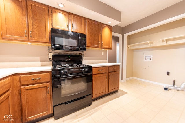 980 Red Maple Ct, Greenwood, IN 46143 - kitchen featuring brown cabinets, baseboards, black appliances, light countertops, and recessed lighting