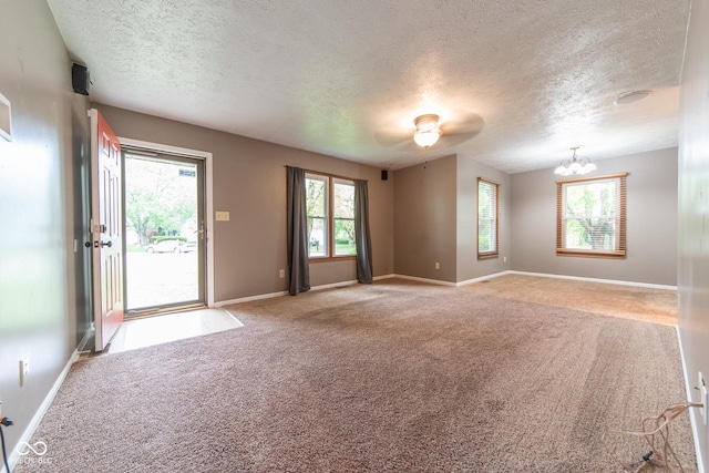 980 Red Maple Ct, Greenwood, IN 46143 - empty room with a chandelier, a textured ceiling, and carpet floors