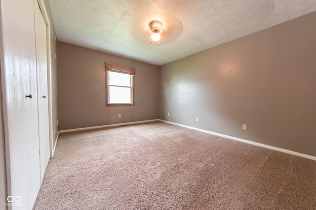 980 Red Maple Ct, Greenwood, IN 46143 - unfurnished bedroom featuring baseboards, light colored carpet, and a textured ceiling