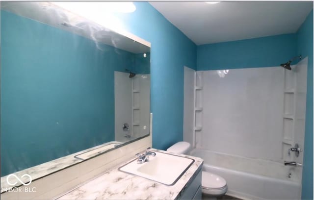 bathroom featuring vanity, toilet, and shower / washtub combination
