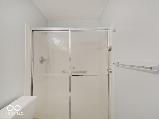 full bath with a shower stall and toilet