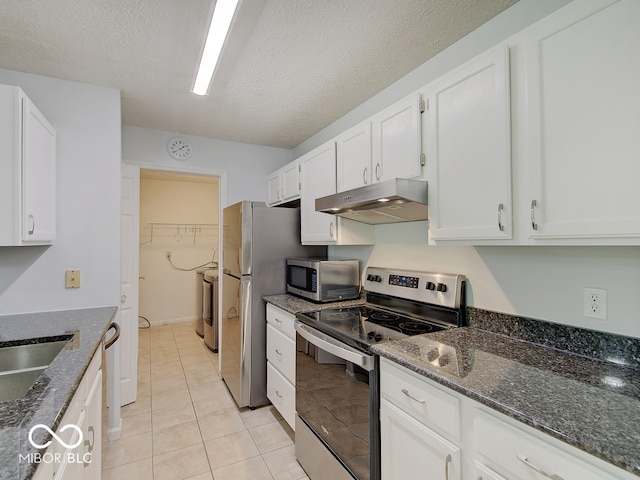 kitchen with stainless steel appliances, under cabinet range hood, white cabinets, dark stone counters, and a textured ceiling