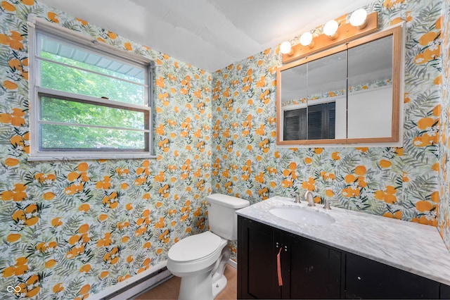bathroom featuring wallpapered walls, vanity, toilet, and baseboard heating