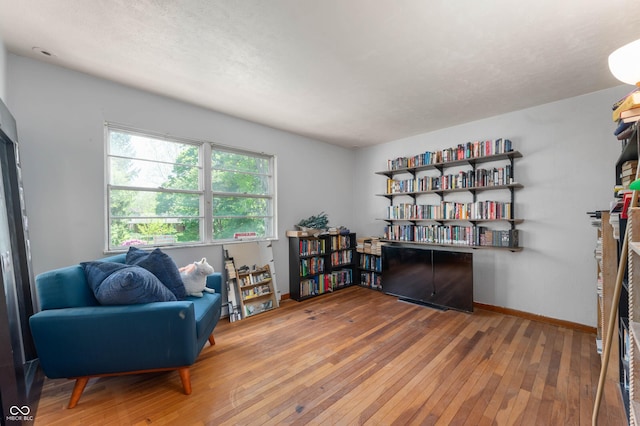 sitting room with wood-type flooring and baseboards