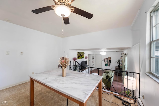 dining room featuring healthy amount of natural light, a ceiling fan, and light tile patterned flooring