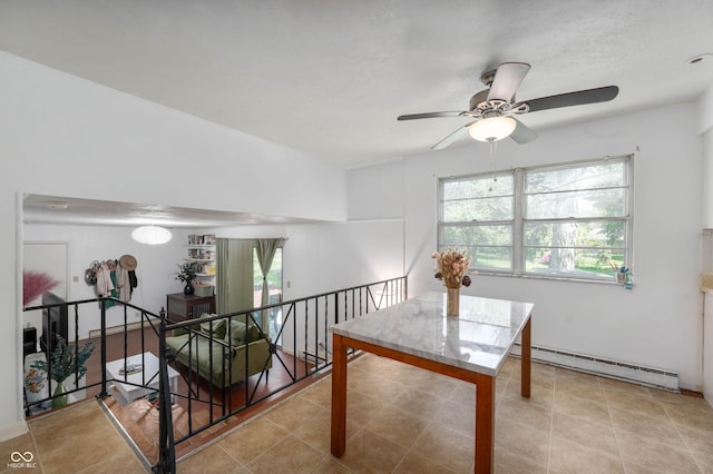 dining room featuring a baseboard heating unit, plenty of natural light, and ceiling fan