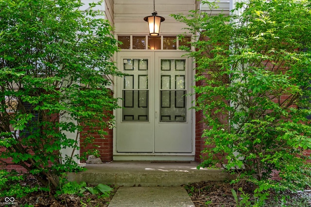 view of exterior entry featuring brick siding