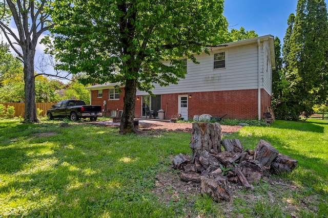 back of property featuring brick siding and a patio area