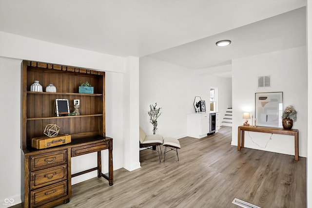 sitting room with wine cooler, light wood finished floors, baseboards, and recessed lighting
