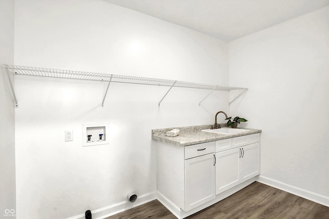 laundry area featuring washer hookup, dark wood finished floors, baseboards, and cabinet space