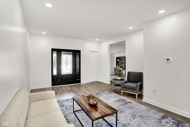 living room featuring wood finished floors, baseboards, and recessed lighting