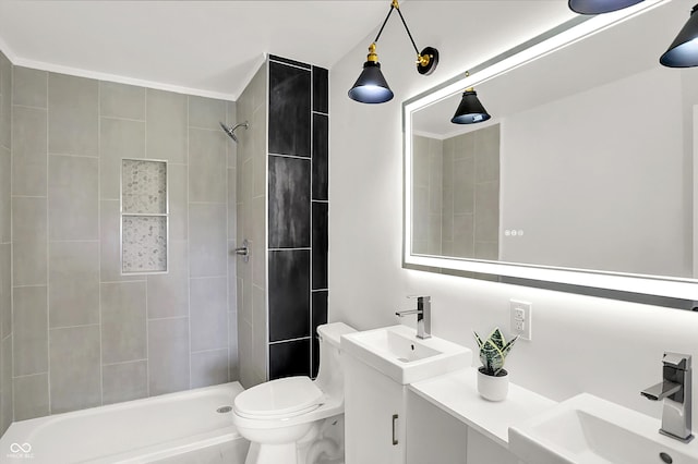 bathroom featuring a tile shower, toilet, and vanity