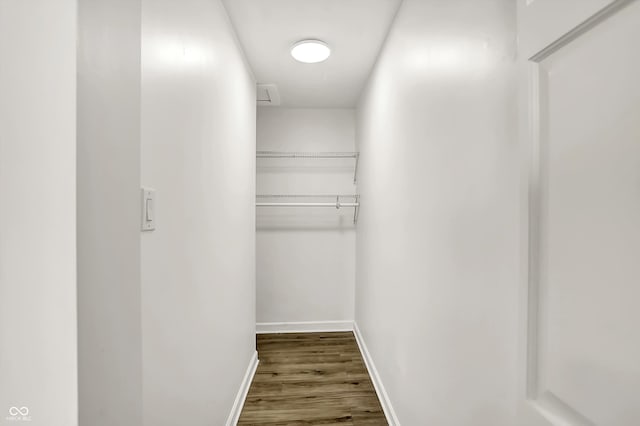 spacious closet with dark wood-type flooring