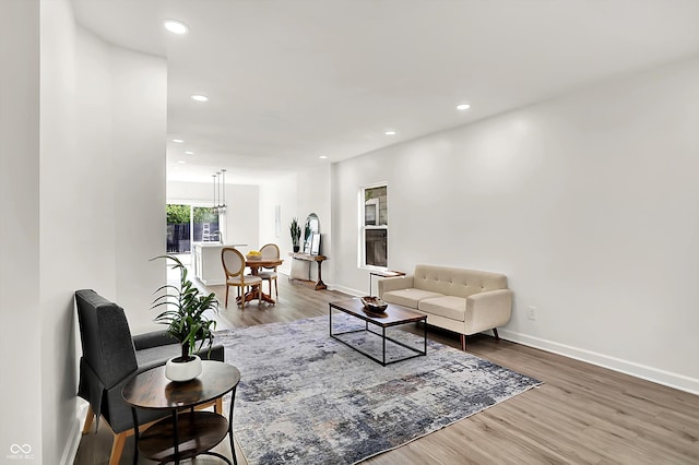living room with wood finished floors, recessed lighting, and baseboards