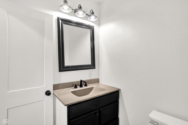 bathroom with toilet and vanity