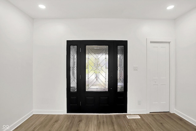 entrance foyer with wood finished floors, baseboards, and recessed lighting