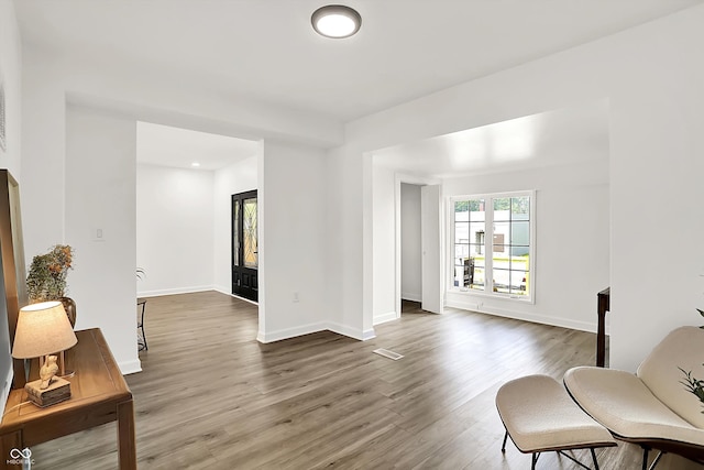 living area featuring wood finished floors and baseboards