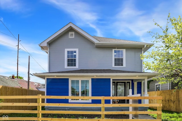 view of front of home with fence and a shingled roof