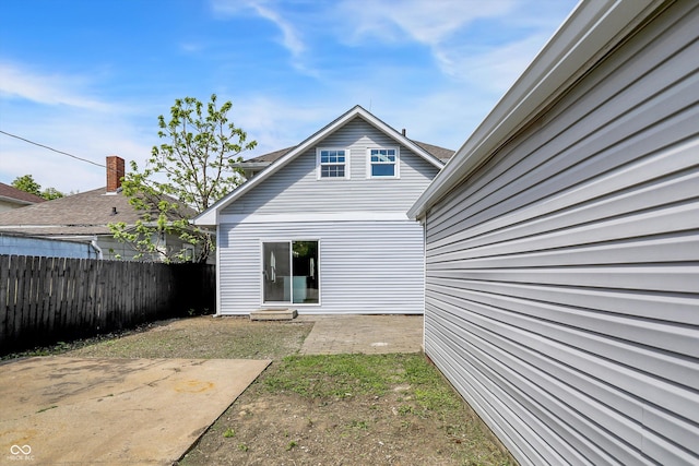 rear view of house featuring fence and a patio area