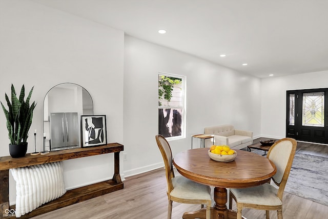 dining room with light wood-style floors, baseboards, and recessed lighting