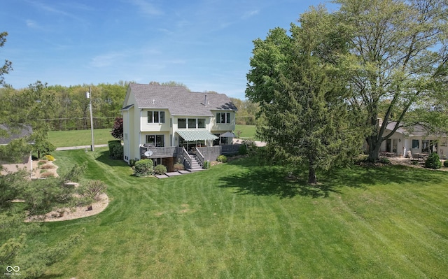 889 E N Shore Dr, Brownstown, IN 47220 - back of property with stairs, a lawn, roof with shingles, and a deck