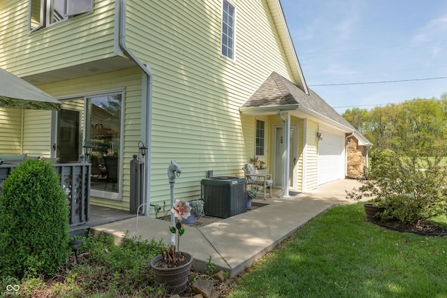 889 E N Shore Dr, Brownstown, IN 47220 - view of property exterior with central air condition unit, a shingled roof, and concrete driveway