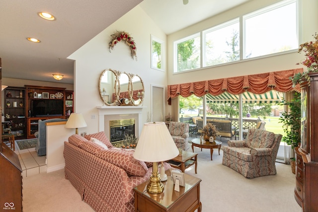 889 E N Shore Dr, Brownstown, IN 47220 - carpeted living room featuring a glass covered fireplace, healthy amount of natural light, recessed lighting, and a towering ceiling