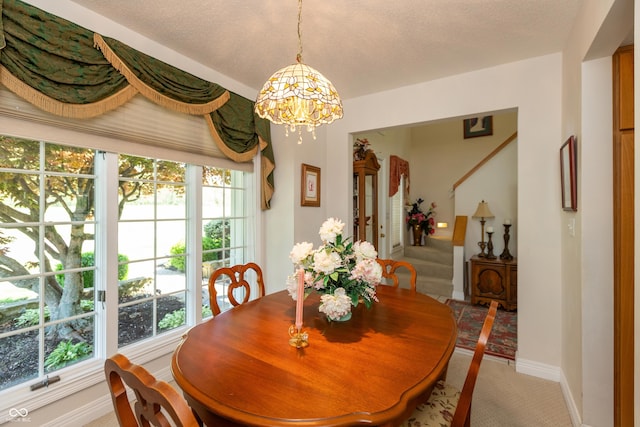 889 E N Shore Dr, Brownstown, IN 47220 - dining space featuring a chandelier, baseboards, and light colored carpet