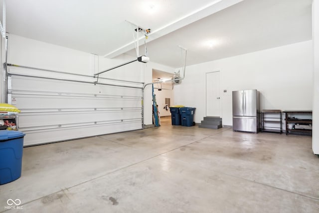 9155 Kerwood Dr, Indianapolis, IN 46240 - garage featuring freestanding refrigerator and a garage door opener