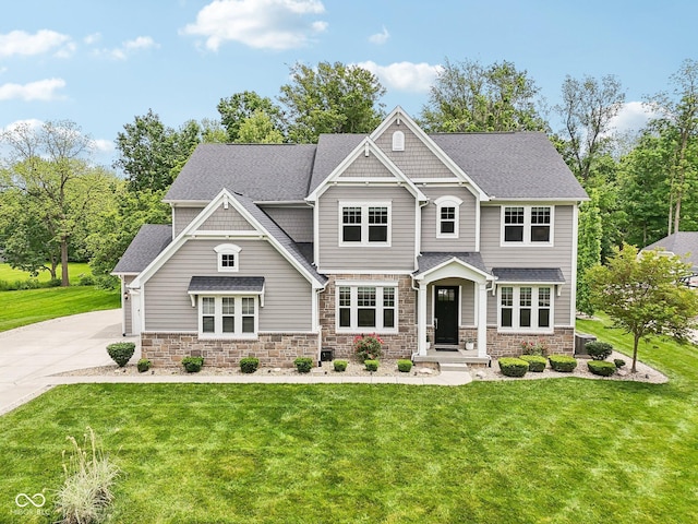 9155 Kerwood Dr, Indianapolis, IN 46240 - craftsman inspired home with stone siding, a front yard, concrete driveway, and roof with shingles