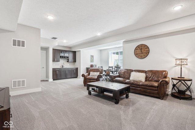 9155 Kerwood Dr, Indianapolis, IN 46240 - living area with light carpet, baseboards, bar with sink, and recessed lighting