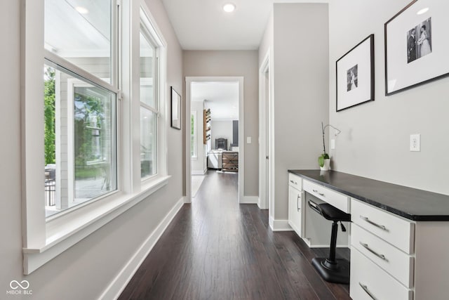 9155 Kerwood Dr, Indianapolis, IN 46240 - corridor with dark wood-type flooring, baseboards, and a desk