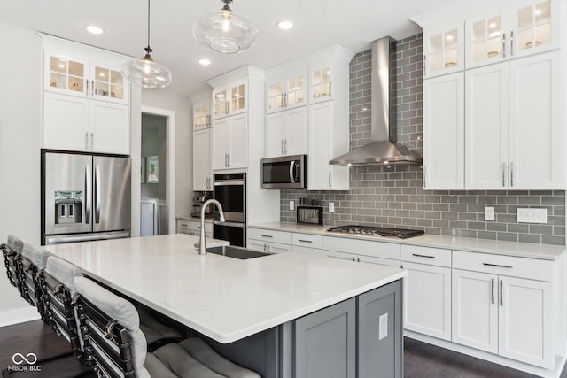 9155 Kerwood Dr, Indianapolis, IN 46240 - kitchen with appliances with stainless steel finishes, wall chimney exhaust hood, a sink, a kitchen island with sink, and dark wood-style floors