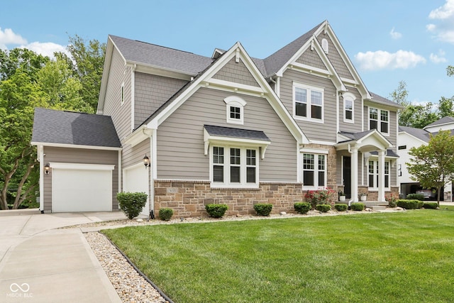 9155 Kerwood Dr, Indianapolis, IN 46240 - craftsman-style house featuring concrete driveway, stone siding, a garage, a front yard, and a shingled roof