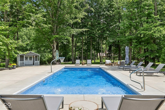 9155 Kerwood Dr, Indianapolis, IN 46240 - outdoor pool with a patio area, view of scattered trees, and an outdoor structure