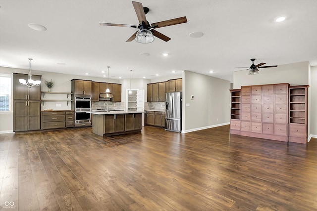 6153 Dugan Dr, Whitestown, IN 46075 - kitchen with appliances with stainless steel finishes, ceiling fan, open floor plan, dark wood-type flooring, and recessed lighting