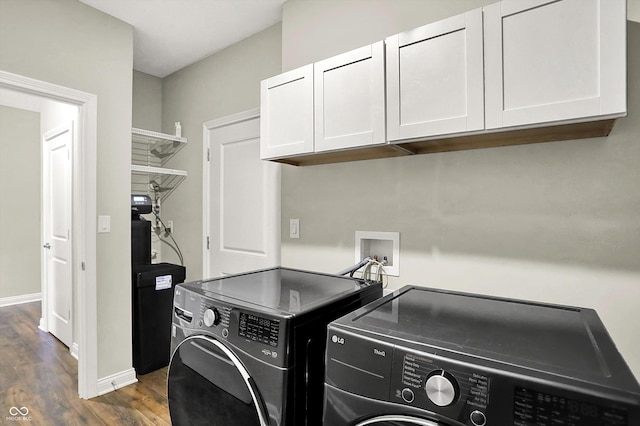 6153 Dugan Dr, Whitestown, IN 46075 - laundry area featuring separate washer and dryer, cabinet space, wood finished floors, and baseboards