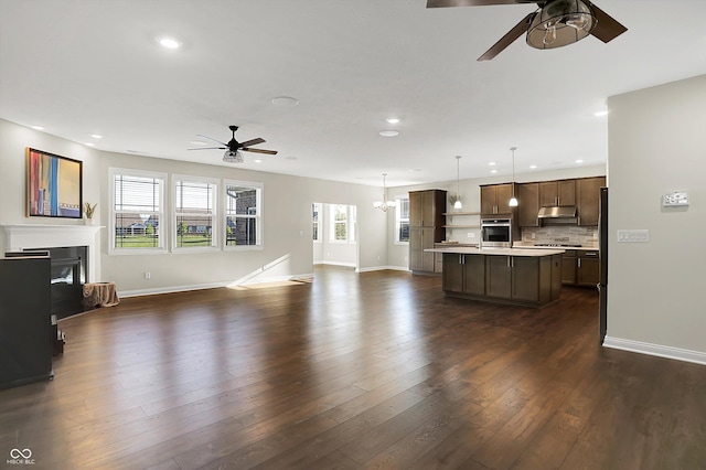 6153 Dugan Dr, Whitestown, IN 46075 - unfurnished living room featuring ceiling fan, recessed lighting, baseboards, and a glass covered fireplace