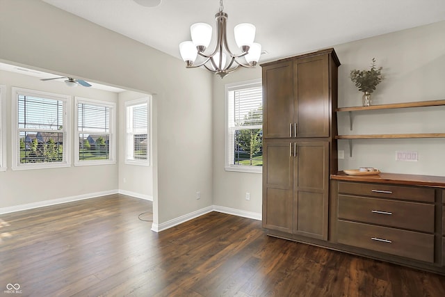 6153 Dugan Dr, Whitestown, IN 46075 - unfurnished dining area featuring a chandelier, dark wood-style floors, baseboards, and ceiling fan
