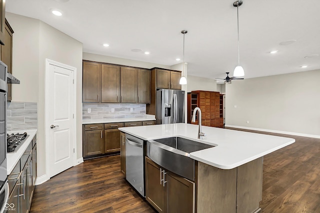 6153 Dugan Dr, Whitestown, IN 46075 - kitchen with appliances with stainless steel finishes, a sink, a ceiling fan, a kitchen island with sink, and decorative backsplash