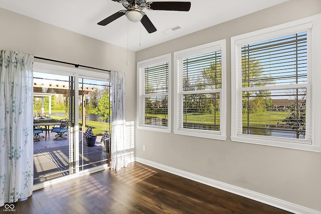 6153 Dugan Dr, Whitestown, IN 46075 - spare room featuring baseboards, dark wood finished floors, a water view, and ceiling fan
