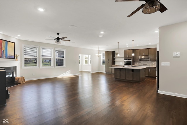 6153 Dugan Dr, Whitestown, IN 46075 - unfurnished living room featuring ceiling fan, recessed lighting, baseboards, a glass covered fireplace, and dark wood-style floors